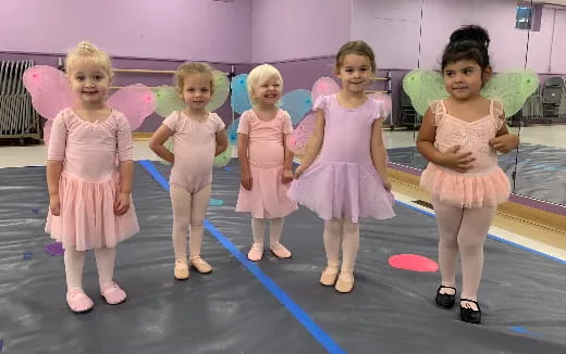 a group of girls in dresses