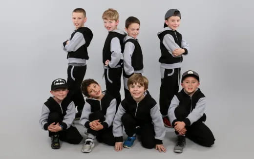 a group of boys in black and white uniforms