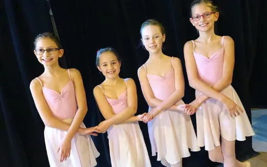 a group of girls in dresses