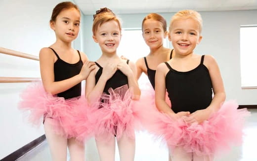 a group of girls in dresses