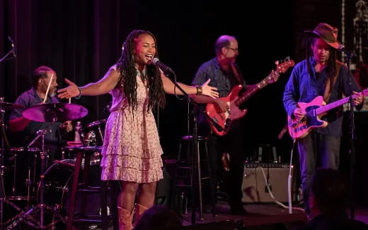 a group of people playing instruments on a stage