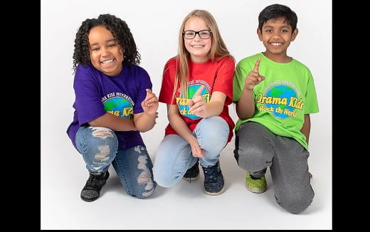 a group of children sitting and smiling