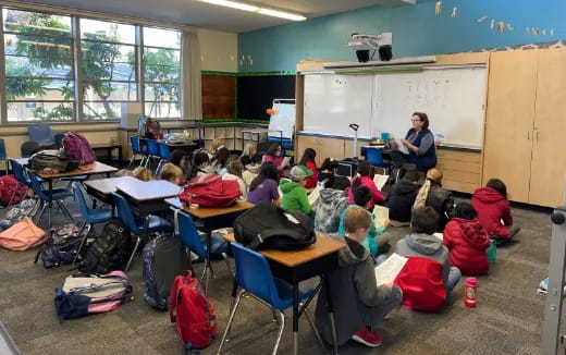 a group of people sitting in a classroom