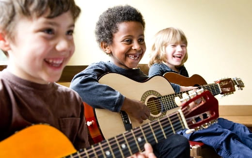 a group of kids playing guitars