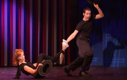 a man and woman dancing on a stage