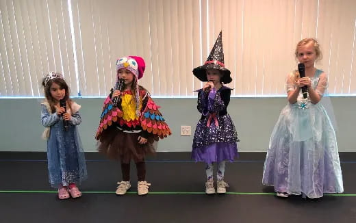 a group of girls in clothing on a stage