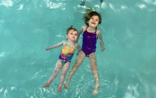 two children in swimsuits in the water