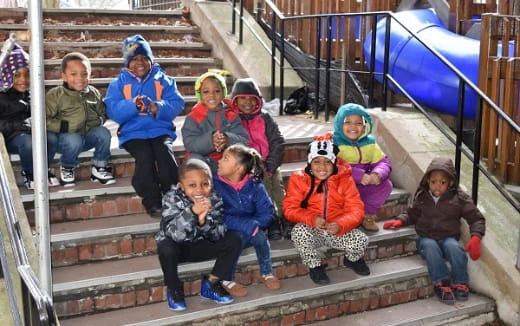 a group of children sitting on stairs