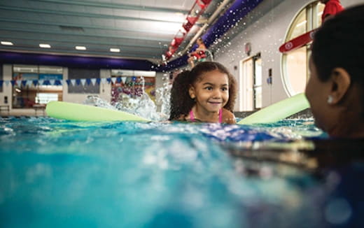 a person and a child in a pool