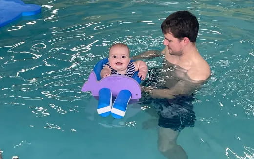 a person and a baby in a pool