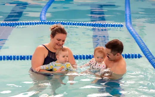 a person and two children in a pool
