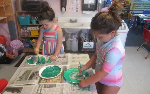 a couple of young girls painting