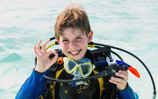a boy wearing goggles and a scuba suit