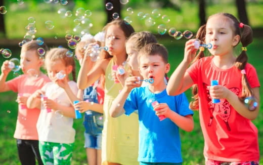 a group of children playing with bubbles