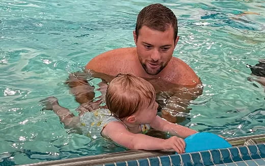 a man and a baby in a pool