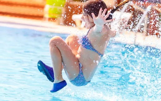 a person in a blue swimsuit in a pool