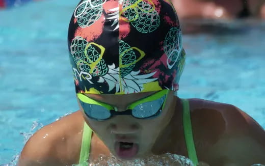 a person wearing goggles and swimming