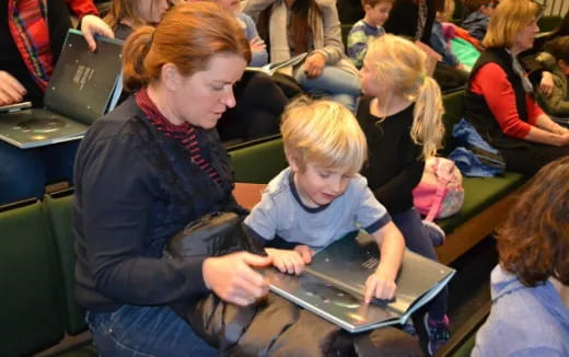 a person and a child using a laptop