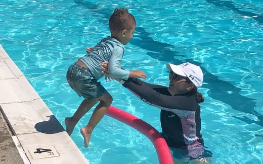 a man and a child in a pool