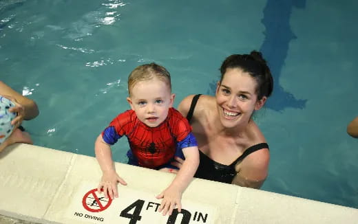 a person and a child in a pool