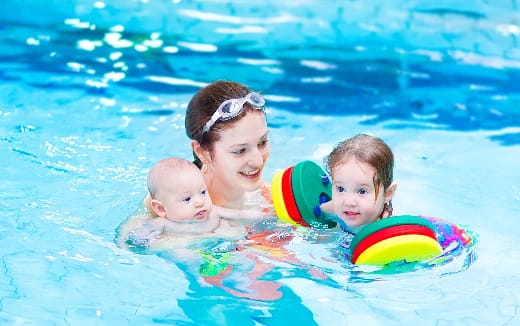 a person and two babies in a pool