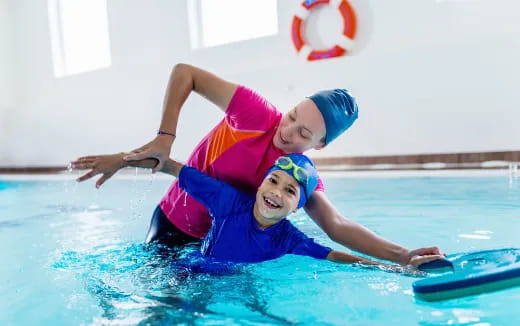 a couple of kids in a pool