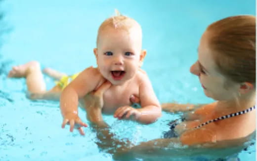 a baby and a person in a pool