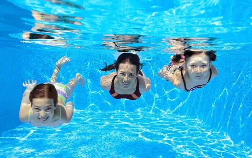 a group of people swimming in a pool