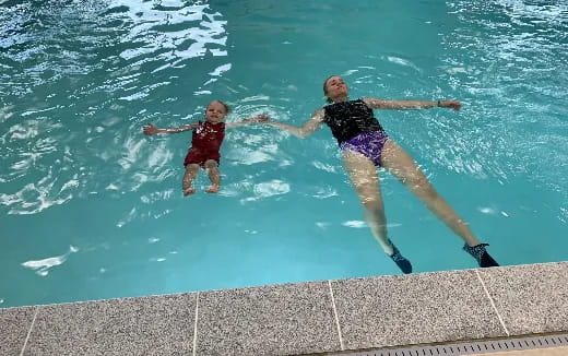 two children jumping into a pool