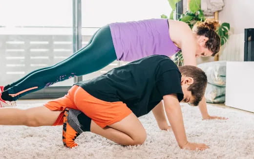 a couple of men doing push ups