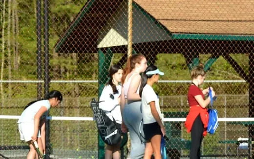 a group of girls playing tennis