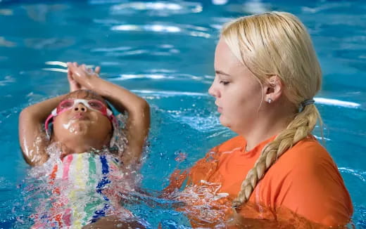 a woman and a baby in a pool