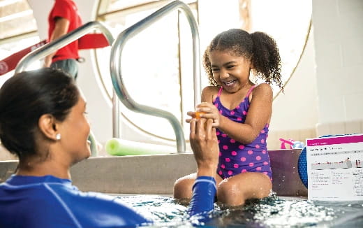 a person and a child playing in a pool