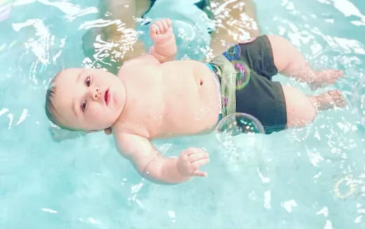 a baby in a pool