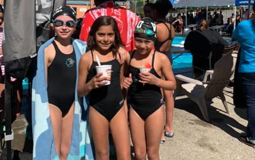 a group of women wearing swimsuits and holding drinks