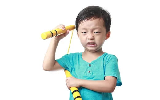 a child holding a yellow toy