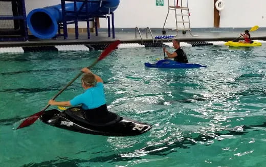 a group of people in kayaks