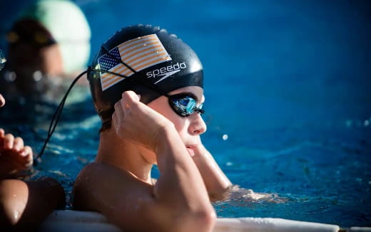 a person wearing goggles and swimming