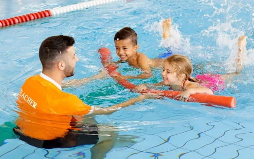 a man and two children in a pool