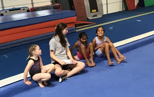 a group of women sitting on the floor