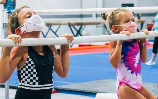 a woman and a girl in a gym