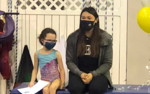 a person and a girl wearing masks