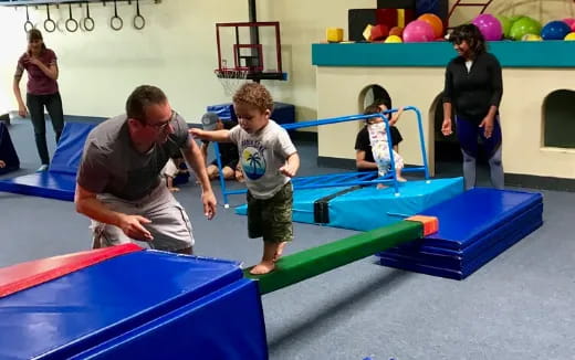 a person and a child playing on a toy pool