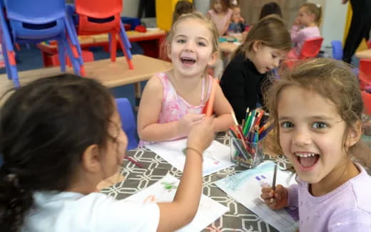 a group of children sitting at a table