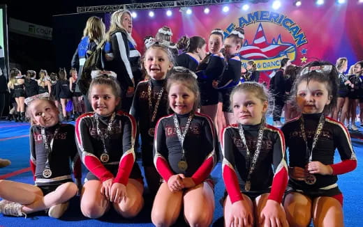 a group of girls wearing track uniforms