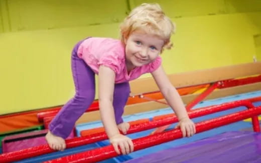 a child on a red and blue mat