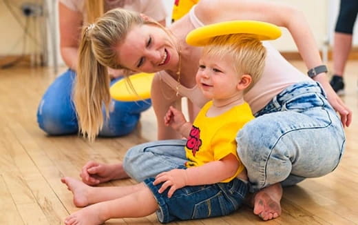 a person and a child playing with a frisbee