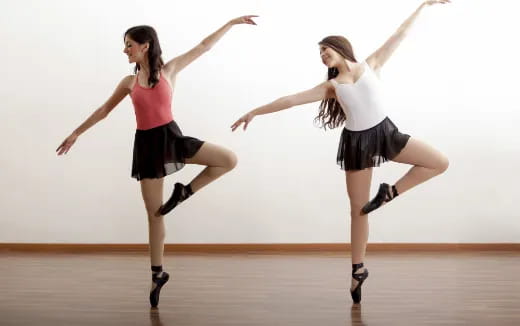 two women dancing on a stage