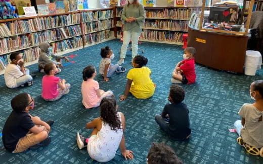a group of children sitting in a library