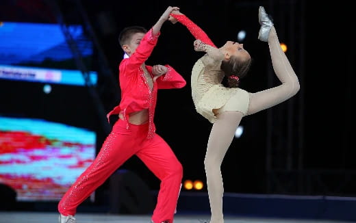 a man and woman dancing on a stage